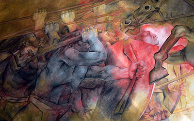 Un mural de Fernando Pacheco que muestra indígenas luchando contra los conquistadores.